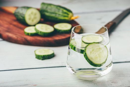 Water infused with sliced cucumber in a drinking glass