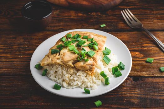 White rice with scrambled eggs with chicken and green onion on plate