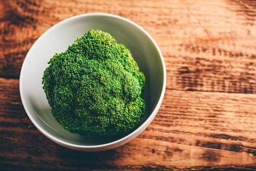 Head of broccoli in bowl ready to be prepared for a recipe