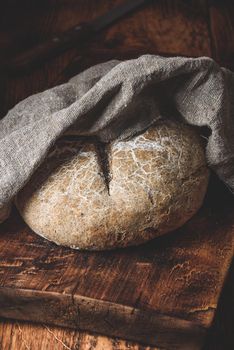 Freshly baked loaf of rye bread on cutting board