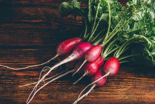 Bunch of fresh red radish on wooden table