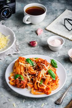 Pasta with mini meatballs, tomato sauce and parmesan cheese