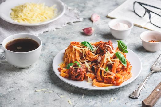 Pasta with mini meatballs, tomato sauce and parmesan cheese