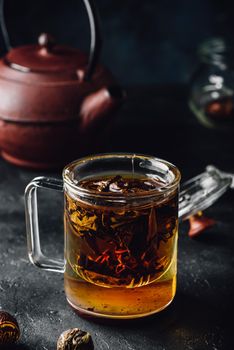 Steeping red tea in glass mug with cap