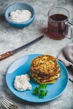 Zucchini parmesan pancakes with dip and parsley