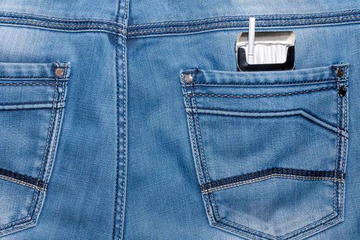 a pack of cigarettes in the back pocket of his pants. High quality photo