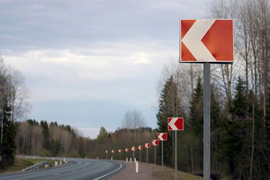 Road signs turning left, sharp turn of the road.