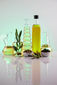 Bottles with organic cooking olive oil and olive branch