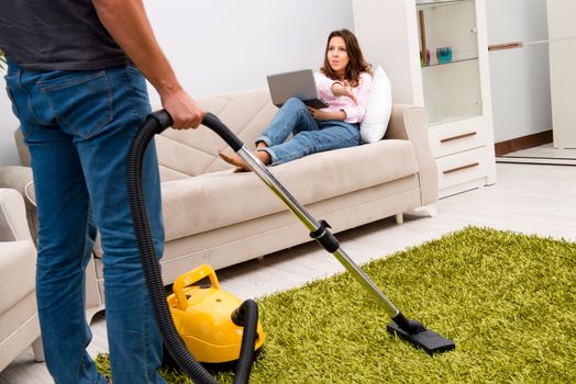 Cleaning the house with vacuum cleaner