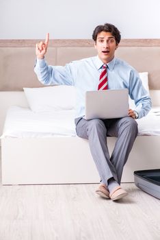 Young handsome businessman preparing for trip