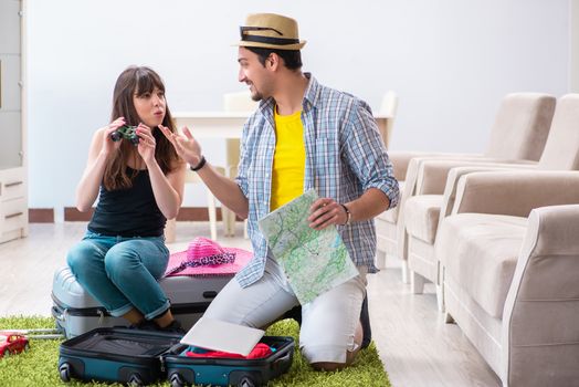 Young family packing for vacation travel