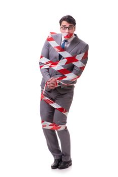 Businessman tied by tape isolated on white