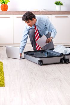 Young handsome businessman preparing for trip