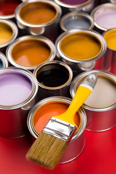 Tin cans with paint, brushes and bright palette of colors