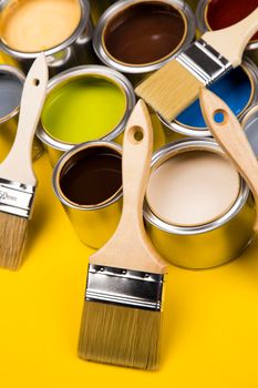 Metal tin cans with color paint and paintbrush