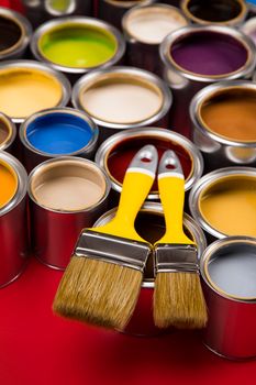 Tin cans with paint, brushes and bright palette of colors