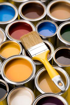 Tin cans with paint, brushes and bright palette of colors