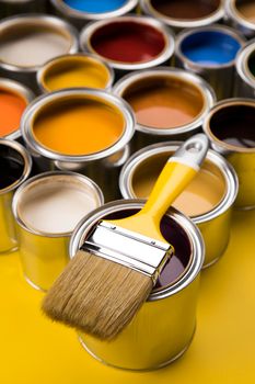 Tin cans with paint, brushes and bright palette of colors