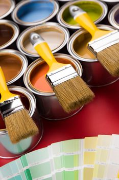 Tin cans with paint, brushes and bright palette of colors