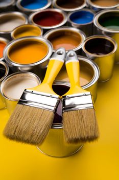 Tin cans with paint, brushes and bright palette of colors