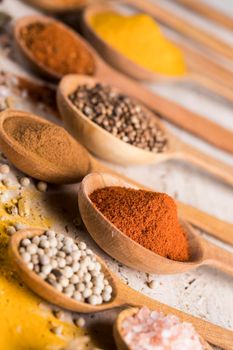 Assortment of spices in wooden bowl background