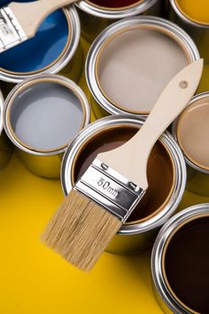 Metal tin cans with color paint and paintbrush