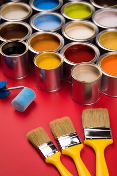 Tin cans with paint, brushes and bright palette of colors