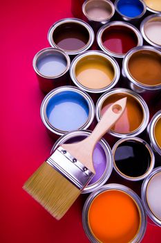 Tin cans with paint, brushes and bright palette of colors