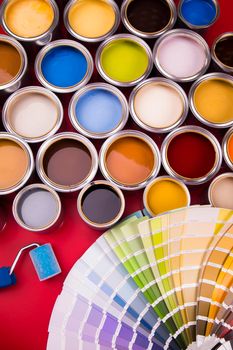 Tin cans with paint, brushes and bright palette of colors