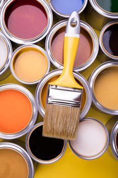 Metal tin cans with color paint and paintbrush