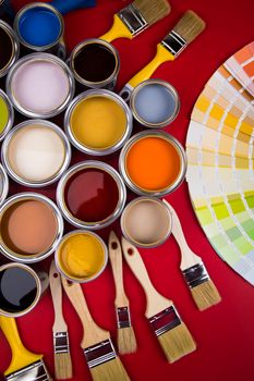 Tin cans with paint, brushes and bright palette of colors