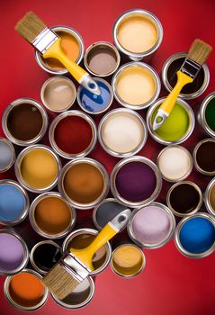 Paintbrush on cans with color