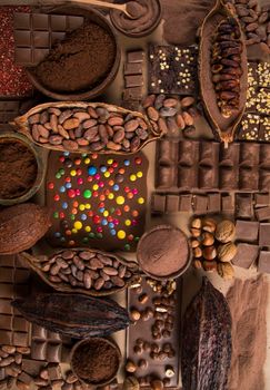 Dark homemade chocolate bars and cocoa pod on wooden