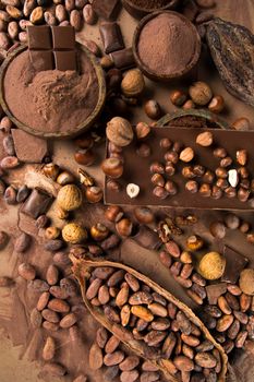 Dark homemade chocolate bars and cocoa pod on wooden