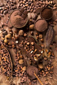 Dark homemade chocolate bars and cocoa pod on wooden