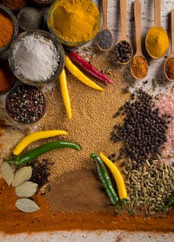 Assortment of spices in wooden bowl background