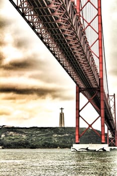 Banks of the river Tagus in Lisbon in Spring on a cloudy day. Beautiful 25th April bridge structure.