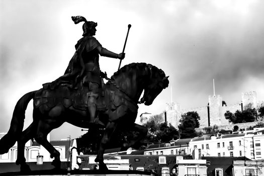 Equestrian statue of Joao I of Portugal in Figueira square in Lisbon. Saint George castle in the background.