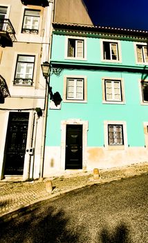 Old colorful and beautiful facades with vintage streetlight in Lisbon streets in Spring.