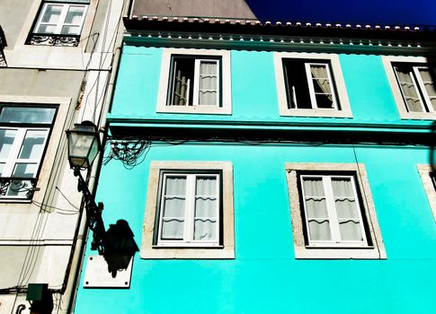 Old colorful and beautiful facades with vintage streetlight in Lisbon streets in Spring.