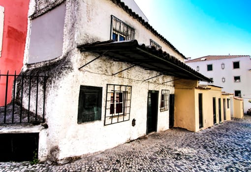 Colorful streets with majestic facades, windows and balconies of Lisbon city in Portugal on a sunny day