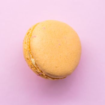 French cake macaron on pink background. Tasty fruit, almond sweet cookie.