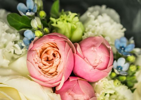 Beautiful flower bouquet arrangement close up in pastel colors. Decoration of roses and decorative plants, selective focus