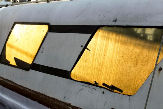 Sun reflected in the window of a fishing boat in southern Spain
