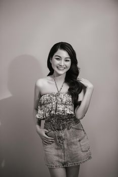 Beautiful sexy asian woman pose against studio background. Black-white photo.