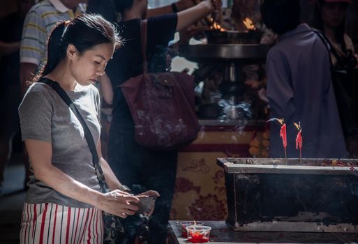 Bangkok, Thailand - 27 Oct 2019 : Interesting Asian women experience Thailand religion culture praying at Dragon Temple Kammalawat (Wat Lengnoeiyi), Wat Leng Noei Yi is the most important Chinese Buddhist temple in Bangkok.