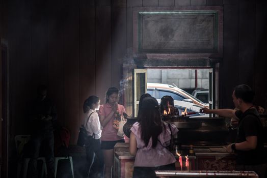 Bangkok, Thailand - 27 Oct 2019 : Attractive asian traveler experience Thailand religion culture praying at Dragon Temple Kammalawat (Wat Lengnoeiyi), Wat Leng Noei Yi is the most important Chinese Buddhist temple in Bangkok.