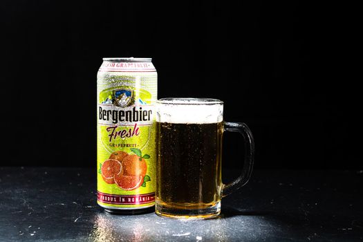 Can of Bergenbier beer and beer glass on dark background. Illustrative editorial photo shot in Bucharest, Romania, 2021