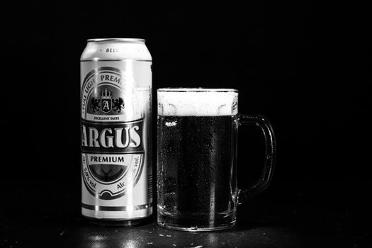 Can of Argus beer and beer glass on dark background. Illustrative editorial photo shot in Bucharest, Romania, 2021