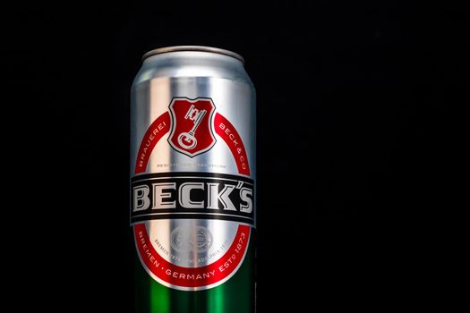 Can of Becks beer on beer barrel with dark background. Illustrative editorial photo Bucharest, Romania, 2021